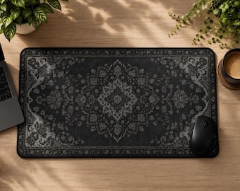 May include: A rectangular desk mat featuring a dark charcoal and black intricate floral medallion pattern reminiscent of a traditional rug design. The mat has a solid black border and a smooth surface, providing a flat area for computer peripherals.