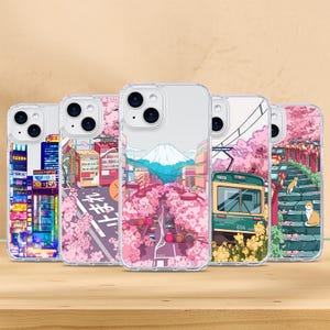 May include: Set of six clear phone cases with different Japanese-inspired designs. The designs include a cityscape, cherry blossoms, a train, and a mountain. The cases are all compatible with iPhone 13 Pro.