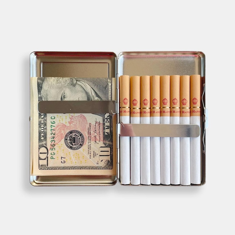 May include: A silver cigarette case with a ten dollar bill inside and a row of cigarettes with red and gold labels that say "Happy" on them.