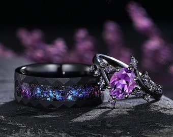 May include: A pair of black wedding bands with a purple gemstone ring. The band on the left has a black and purple galaxy design. The ring on the right has a large oval purple gemstone surrounded by smaller purple gemstones.