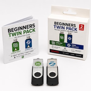 Könnte beinhalten: Ein Beginners Twin Pack mit zwei USB-Sticks, einer mit Linux Mint und einer mit Zorin OS Branding, inklusive weißer Pappschachtel und einer Kurzanleitung. Die Sticks haben ein schwarzes Gehäuse und eine schwenkbare silberne Abdeckung.