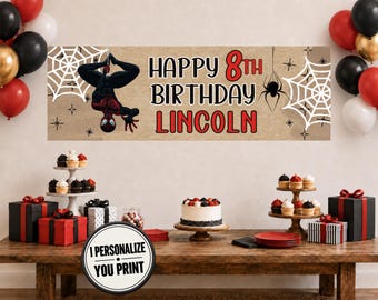 May include: A rectangular birthday banner with a tan background featuring a black and red superhero character hanging upside down, white spiderwebs, and black spiders. The text reads HAPPY 8TH BIRTHDAY LINCOLN in black and red lettering.