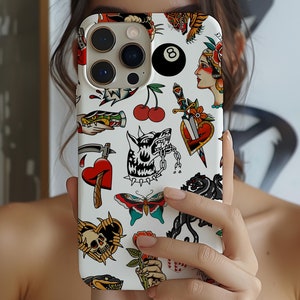 May include: White iPhone case with a colorful tattoo-style design. The design features a skull, a heart, a wolf, a butterfly, a dagger, a cherry, and a 8-ball.