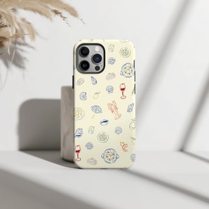May include: A white iPhone case with a pattern of various food items, including pasta, wine glasses, and seafood. The case has a camera cutout and a cream background.