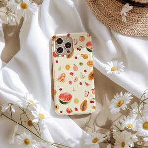 May include: A white phone case with a colorful fruit pattern. The case features watermelons, strawberries, cherries, peaches, and papayas.