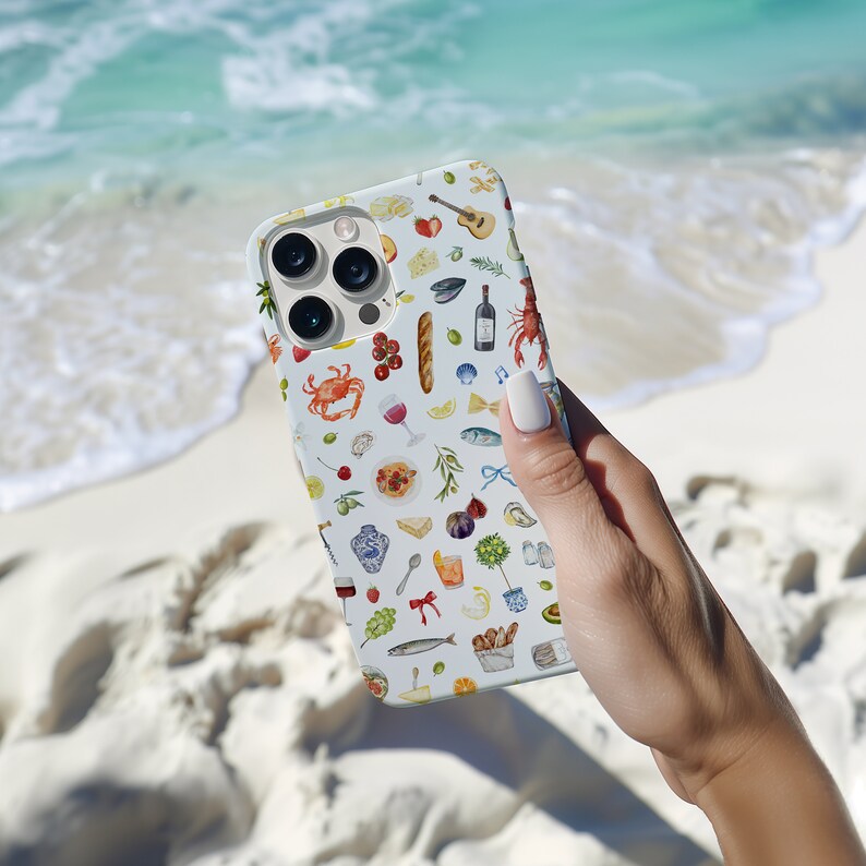 Puede incluir: Funda de tel&eacute;fono azul claro con un dise&ntilde;o de acuarela de alimentos y bebidas. El dise&ntilde;o incluye una langosta, una copa de vino, una baguette, queso y otros elementos culinarios. La funda se sostiene sobre un fondo de playa arenosa y oc&eacute;ano.