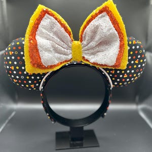 Candy Corn inspired mouse ears. Large Halloween bow on Mickey ears.
