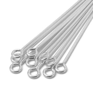 May include: A bundle of silver-toned jump rings with a loop at one end. The rings are arranged in a fan shape.