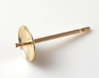 May include: Gold earring finding with a flat round disc and a post.