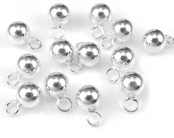 May include: Silver-toned metal bead charms with a loop on each end. The beads are round and have a smooth, shiny finish.