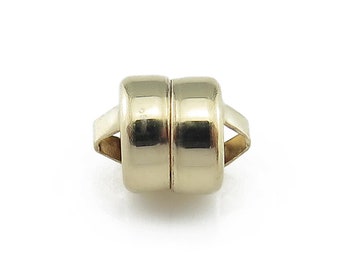 May include: A pair of gold-toned magnetic clasps for jewelry making. The clasps are round and have a smooth finish.