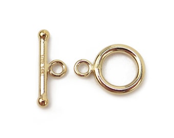 May include: Gold-toned toggle clasp with a round ring and a bar with a small loop on each end. The bar is marked "1/20 14K".