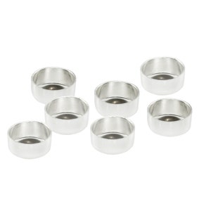 May include: Set of seven silver-coloured metal candle holders. The holders are round and have a smooth, shiny finish.