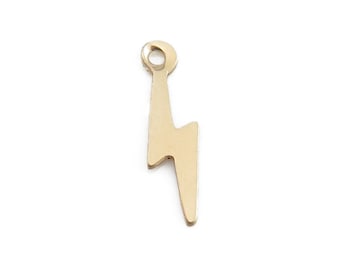 May include: Gold-toned metal charm shaped like a lightning bolt with a loop at the top for attaching to jewelry.