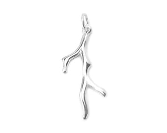 May include: A silver charm in the shape of a branch. The charm is detailed and has a smooth finish.