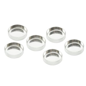 May include: Six small, round, silver-colored metal bezels are arranged on a white background. Each bezel has a shallow, concave interior. The bezels are likely used for jewelry making or crafting projects.