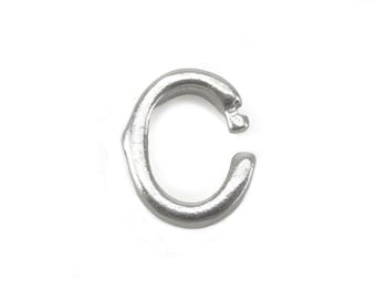 May include: A silver-toned metal charm shaped like the letter C. The charm has a slightly rough, textured surface.