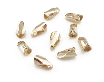 May include: Ten gold-toned metal end caps for jewellery making. The end caps are shaped like a teardrop with a small loop at the top.