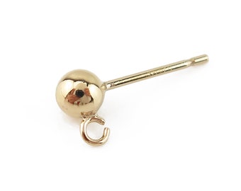 May include: A gold-toned earring with a small ball at the end and a loop on the side. The earring post is straight and has a small, flat end.