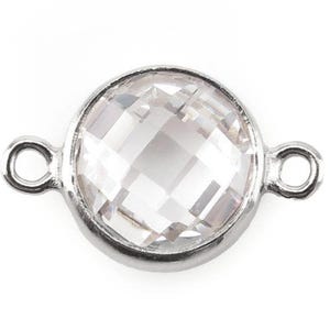 May include: Silver connector with a clear faceted crystal bead. The connector has two loops on either side for attaching to jewelry.