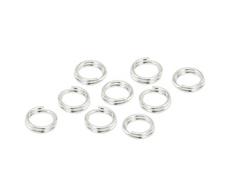 May include: A collection of silver-colored split rings, commonly used in jewelry making and crafts. The rings are arranged on a white background, showcasing their circular shape and split design. These small, metallic components are ideal for connecting various elements.