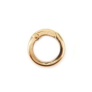 May include: A gold-coloured, circular clasp with a hinged opening. The clasp is made of metal and has a smooth, reflective surface. The clasp is designed to open and close, for use in jewellery or accessories.