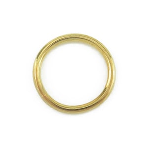 May include: A gold ring, circular in form, set against a white backdrop. The ring has a smooth, polished surface and a warm, yellow hue. The ring is a jewelry item.