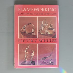 May include: A book titled "Flameworking: Glassmaking for the Craftsman" by Frederic Shuler. The cover features four images of glass sculptures.