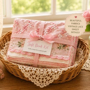 May include: A stack of pink and white fabric pieces tied with a pink ribbon in a wicker basket. A tag reads Soft Book Kit, Craft a book for a special gift. A circular label reads BEAUTIFUL FABRICS, VINTAGE LACE, SWEET DETAILS.