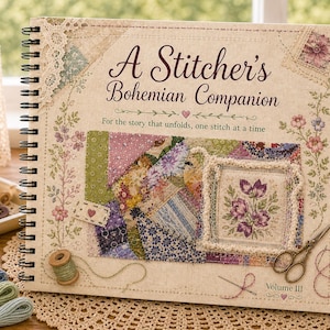 May include: A spiral-bound book titled "A Stitcher's Bohemian Companion" with floral and patchwork designs. The cover features the text "For the story that unfolds, one stitch at a time" and "Volume III". A tray of buttons and spools of thread are also visible.