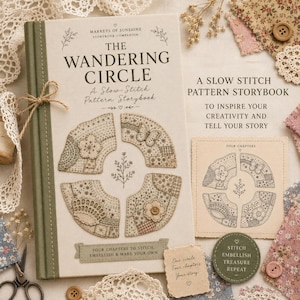 May include: A hardcover book titled The Wandering Circle, A Slow-Stitch Pattern Storybook, featuring an olive green spine and cream cover with embroidered circular patterns, butterfly and flower motifs, and text detailing four chapters to stitch.