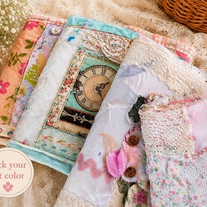 May include: A collection of fabric covers featuring patchwork designs with floral patterns, lace trim, and a clock face graphic. The items include various textures, buttons, and pastel colors. A circular label with the text Pick your kit color is visible.