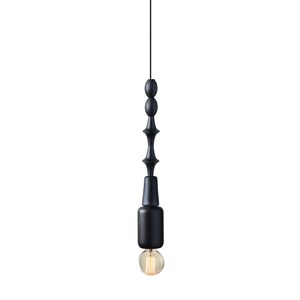 Black wooden pendant light with geometric sculptural design and Edison bulb, creating a bold, industrial statement in modern interiors