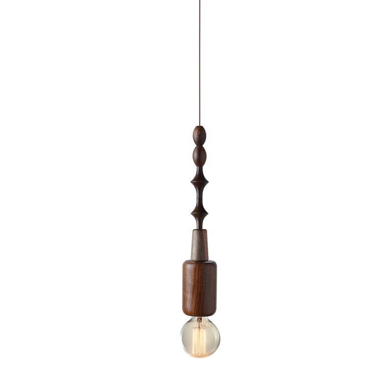 Dark wood pendant light featuring unique sculptural lines and Edison bulb, adding a touch of rustic sophistication to urban loft spaces