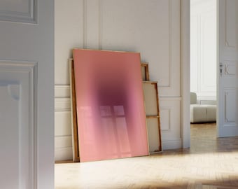 May include: A large, framed abstract painting with a pink to purple gradient. The painting is leaning against a white wall in a room with wooden floors.