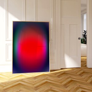 May include: A framed abstract art print with a gradient of colours, including red, pink, purple, and blue, creating a circular shape in the centre.