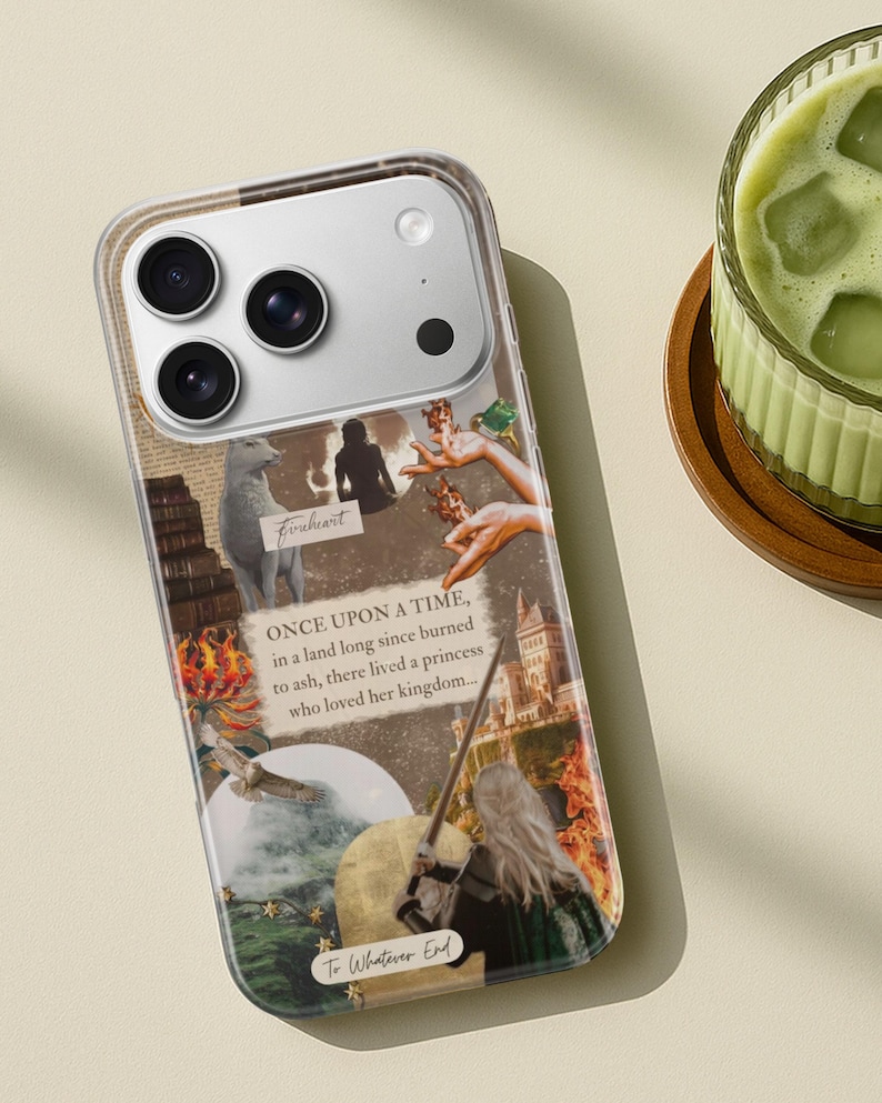 May include: A clear smartphone case featuring a collage of fantasy-themed imagery, including a white wolf, a castle, flames, and a person with long blonde hair holding a sword. The text reads: "ONCE UPON A TIME, in a land long since burned to ash, there lived a princess who loved her kingdom...", "Fireheart", and "To Whatever End".