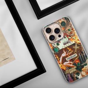 May include: A clear smartphone case featuring a vibrant collage design with orange flames, a sword, a cross, and hands. The text reads "You do not yield," "FIREHEART," and "FIRE BREATHING QUEEN." The case has a cutout for a triple-lens camera system.