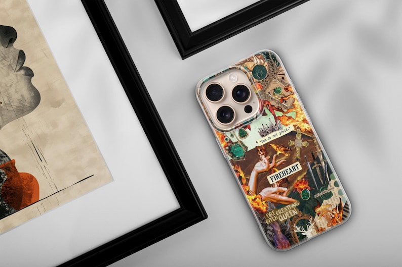 May include: A clear smartphone case featuring a vibrant collage design with orange flames, a sword, a cross, and hands. The text reads "You do not yield," "FIREHEART," and "FIRE BREATHING QUEEN." The case has a cutout for a triple-lens camera system.