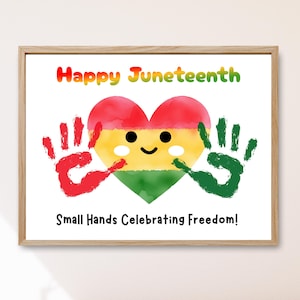 May include: A framed print with the words "Happy Juneteenth" in colorful letters above a heart-shaped design. The heart is red, yellow, and green, with a smiling face and handprints on either side. The text "Small Hands Celebrating Freedom!" is below the heart.