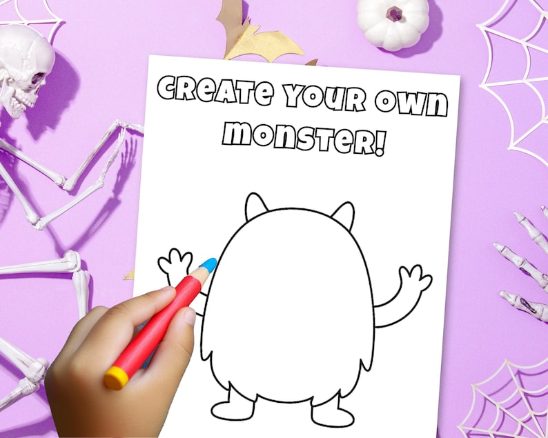 May include: A white coloring page with the text "CREATE YOUR OWN MONSTER!" features a cartoon monster outline. A hand holds a red crayon with a blue tip, coloring the monster. Halloween-themed decorations surround the page.