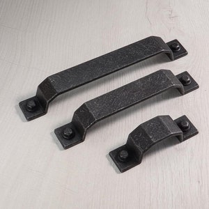 May include: Three black metal door handles of different sizes. The handles have a distressed finish and are designed for a rustic or industrial look.