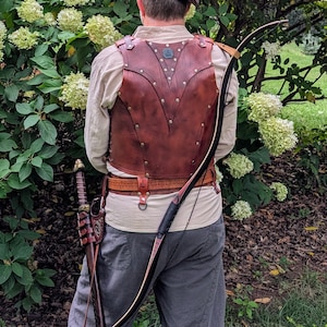 May include: A white ceramic mug with a black handle and the text "But First, Coffee" in a black, bold font. The mug is on a white surface.