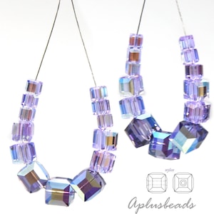May include: Two strands of light purple cube-shaped beads with an iridescent finish. The beads vary in size, with larger cubes at the bottom of each strand. A small diagram labeled #5601 and the text Aplusbeads are visible in the corner.