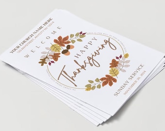 May include: A pile of white Thanksgiving service leaflets. The design features a circular wreath of autumn leaves and the words "Happy Thanksgiving" in a script font. The text "Sunday Service November 20, 2024" is also visible.