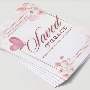 May include: A stack of pink and white brochures with a gold border and a butterfly graphic. The text on the brochure reads "Saved by Grace" and "Women's Ministry Conference" with the date "October 20, 2024".