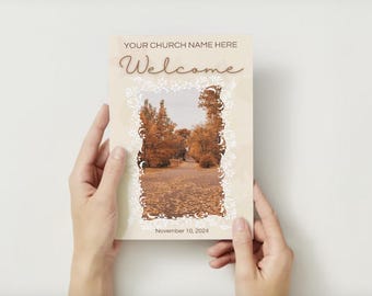 May include: A welcome sign with an autumnal image of a path through trees with a white ornate border. The text "YOUR CHURCH NAME HERE" and "Welcome" are in brown text. The date "November 10, 2024" is at the bottom.
