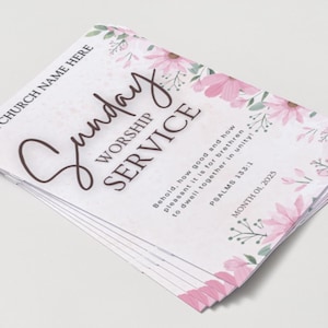 May include: A stack of white Sunday Worship Service flyers. The flyers have pink floral accents and text that reads "Sunday Worship Service" and "Your Church Name Here". The text also includes a Bible verse.