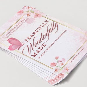 May include: A stack of pink and white event flyers with floral and butterfly designs. The text reads "Fearfully Wonderfully Made Women's Ministry Conference" and includes the date "October 20, 2024".