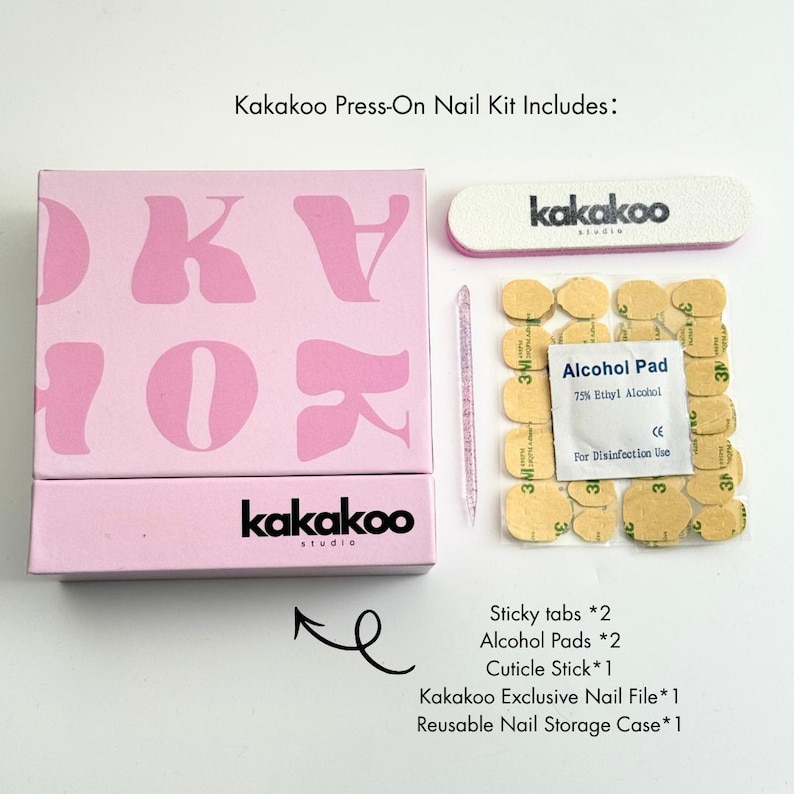 May include: A pink Kakakoo press-on nail kit with a box, nail file, alcohol pads, cuticle stick, and sticky tabs. The box has the brand name and logo in black and pink. The kit includes a reusable nail storage case.